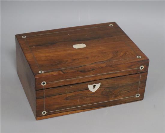 A rosewood mother of pearl inlaid sewing box